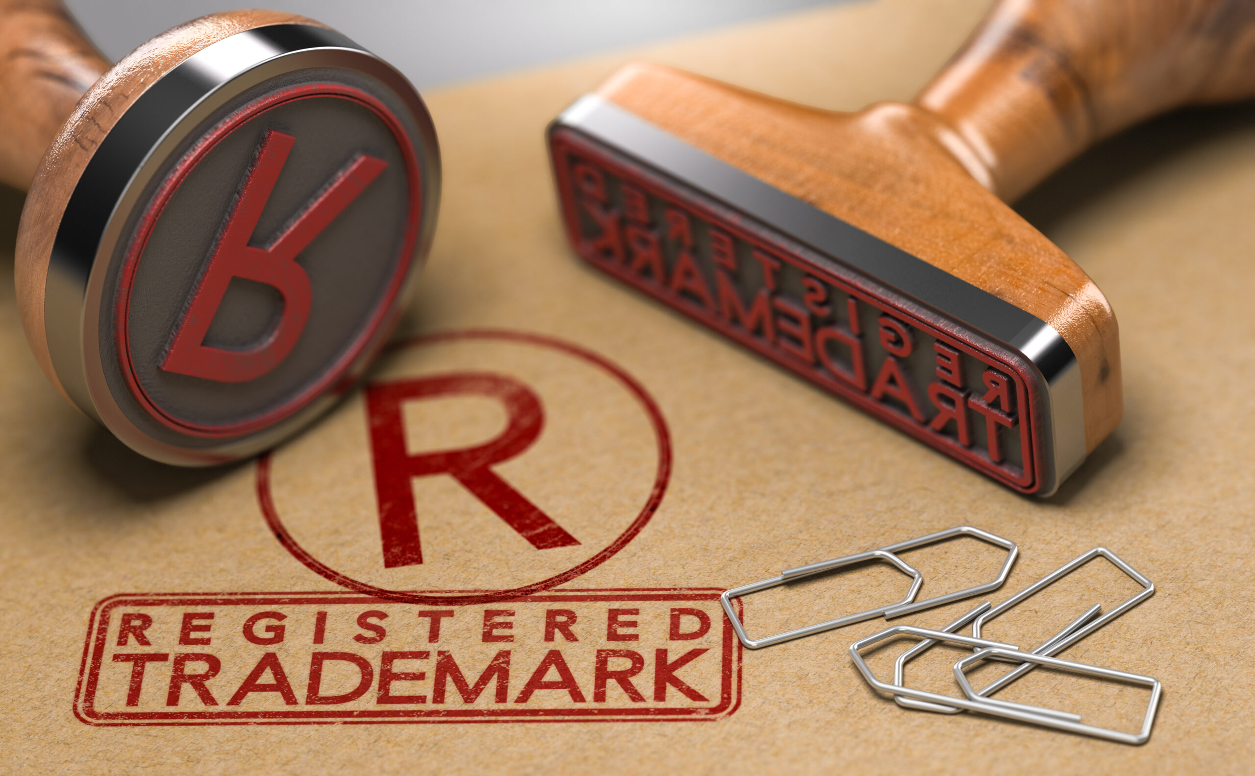 3d illustration of two rubber stamps with Registered Trademark text and the R registration symbol